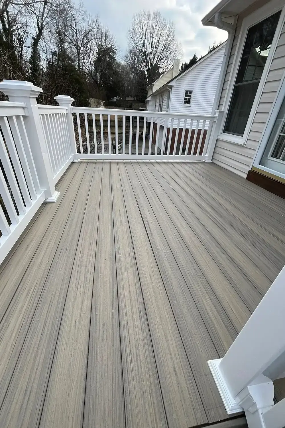 Restored deck with composite boards and clean white railings